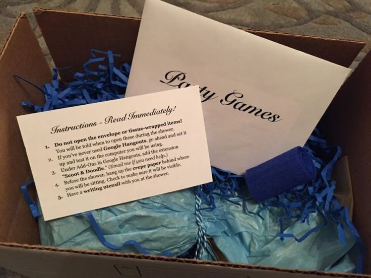 an open box with blue shredded paper and a sign that says dry games in it