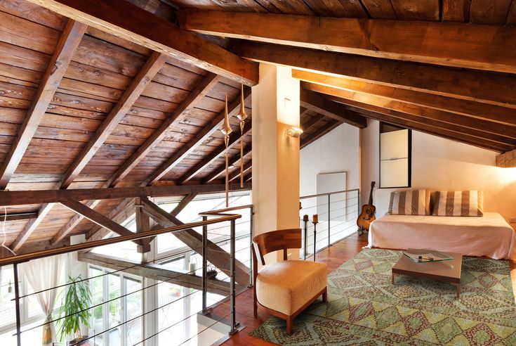 a bedroom with wooden ceilings and green carpet