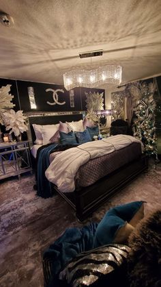 a bed room with a neatly made bed and chandelier