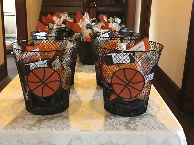 two baskets with basketballs on them sitting on a table