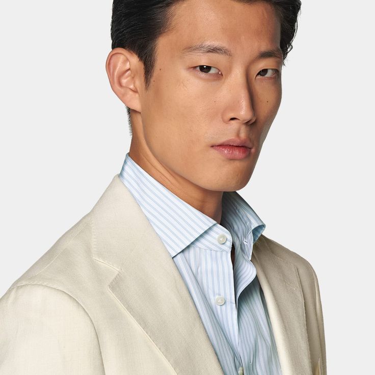 Cut to a relaxed fit, this off-white suit features a jacket with a natural shoulder and accompanying flat-front trousers with a straight-leg and belt loops. Cream Linen Suit For Semi-formal Occasions, White Linen Blazer With Notch Lapel, Timeless Formal Suits For Spring, White Notch Lapel Blazer With Concealed Placket, Cream Linen Suits For Spring, Cream Linen Suit For Spring, White Linen Semi-formal Suits, White Long Sleeve Blazer With Pressed Crease, Summer Formal Cream Blazer