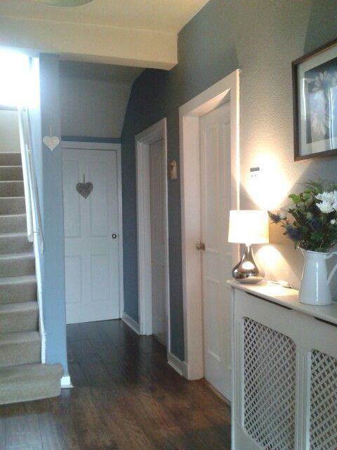 an instagram photo of a house with stairs and light on the door, next to a lamp