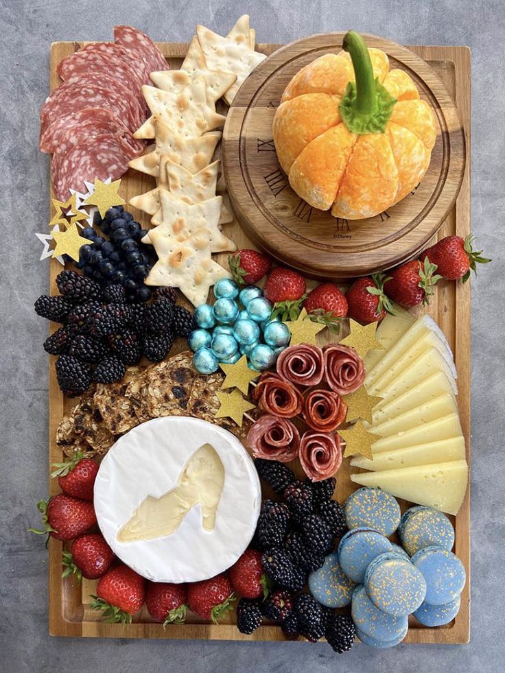 an assortment of meats and cheeses on a platter