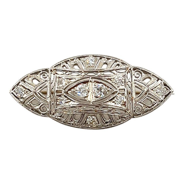 This exquisite brooch showcases approximately 1.00 carat round diamond with VS2 clarity and F color grade. Set in a blend of platinum, and 18k white gold, the intricate design highlights the Art Deco style. Measuring 1.62 inches in length and 0.75 inches in width, this piece is a remarkable addition to any collection. Crafted in the United States in 1930. Stile Art, Gem Diamonds, Diamond Brooch, Estilo Art Deco, Fine Jewelry Designers, Color Grading, Art Deco Fashion, Round Diamond, Round Diamonds