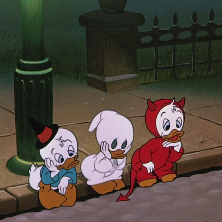 three cartoon characters sitting on the ground near a lamp post and fenced in area