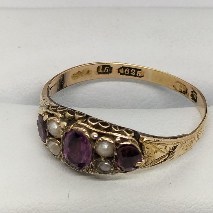 Victorian 15 Ct Solid Gold Ring With Three Amethyst & Four Seed Pearl the ring size is P. Hallmarked 15 Ct (625) Gold Birmingham Victorian ERA (1837 - 1901) In such beautiful condition for the age Victorian Oval Amethyst Ring With 17 Jewels, Antique Pearl Ring With Gemstone, Antique 14k Stamped Amethyst Ring, Victorian Yellow Gold Amethyst Gemstone Ring, Victorian Yellow Gold Amethyst Ring, Estate Style Gemstone Wedding Rings, Antique Collectible Birthstone Ring, Victorian Multi-stone Ring For Anniversary, Victorian 14k Gold Ring In Purple