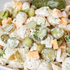 a white bowl filled with cucumber and cheese salad