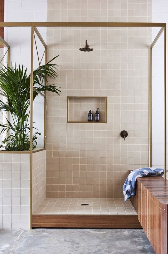 a bathroom with a shower, toilet and plant in it on the counter top next to the bathtub