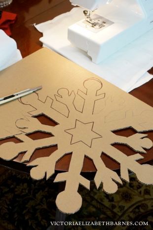 a paper snowflake cut out on a table next to a pair of scissors