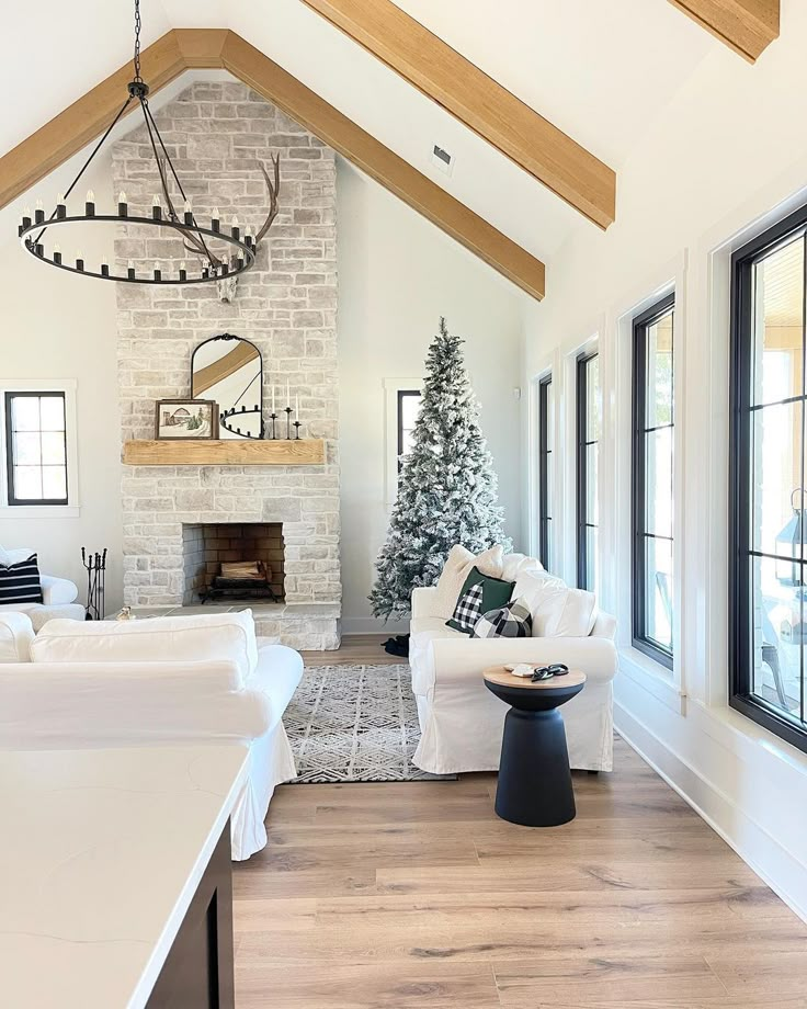 a living room filled with furniture and a christmas tree in the middle of the room