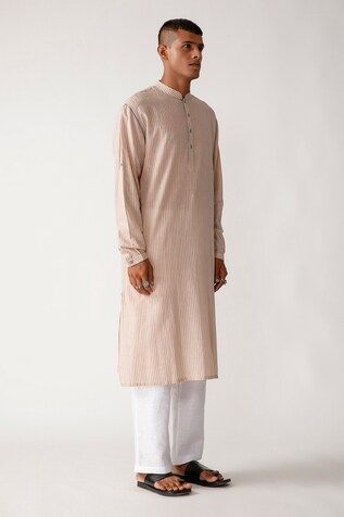 Beige straight long kurta with striped detail, 4-button placket, cuff sleeves and hand made detachable pea- buttons. Comes with ivory pants.
Component: 2
Neckline: Mandarin Collar
Sleeve Length: Full
Fabric: Handloom Cotton
Color: Beige, White
Cuff sleeves
Button placket
Striped pattern - Aza Fashions Ivory Pants, Kurta Set Men, Men Kurta, Long Kurta, Kurta Set, Mandarin Collar, Cuff Sleeves, Aza Fashion, Stripes Pattern