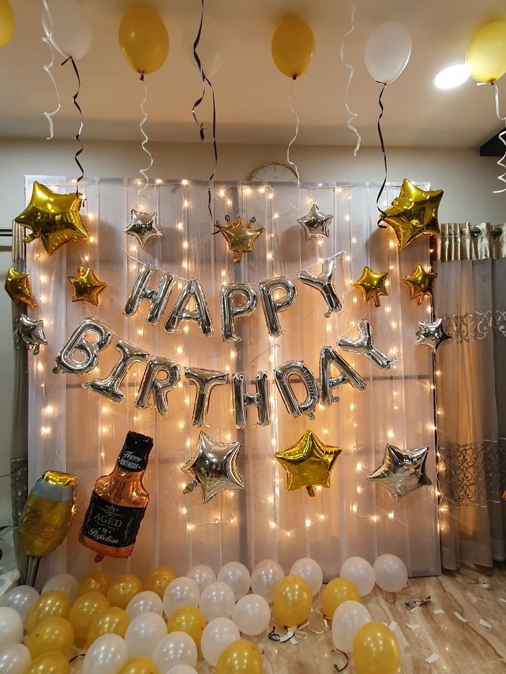 a birthday party with balloons and confetti in front of a backdrop that says happy birthday