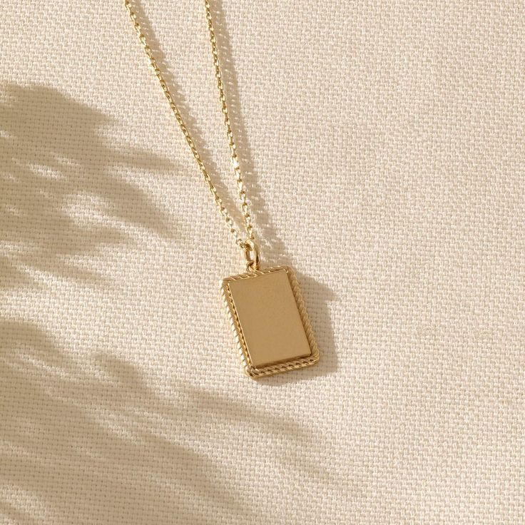 If you have something very special in your mind and want to demonstrate it all the time, our Engravable Pendant, elegantly designed and made with minimalist style, is always here to carry out and reflect your values, with an impeccable pride. - Made in 14k solid gold- Pendant, 17.35x10.25 mm / 0,68x0,40 inches- Thickness, 1.28 mm / 0,05 inches- It can be used with up to 3 mm chains. If you are to use it with a thicker chain, please let us know before you make the purchase. - This product comes w Elegant Engraved Necklace With Rectangular Pendant, Minimalist Engraved 14k Gold Filled Necklaces, Dainty 14k Gold Rectangular Pendant Charm Necklaces, Elegant Gold Rectangular Charm Necklace, Elegant Gold Plated Charm Necklaces With Rectangular Pendant, Elegant Gold Plated Charm Necklace With Rectangular Pendant, Minimalist Formal Necklaces With Rectangular Pendant, Minimalist Formal Jewelry With Rectangular Pendant, Timeless 14k Gold Necklace With Rectangular Pendant