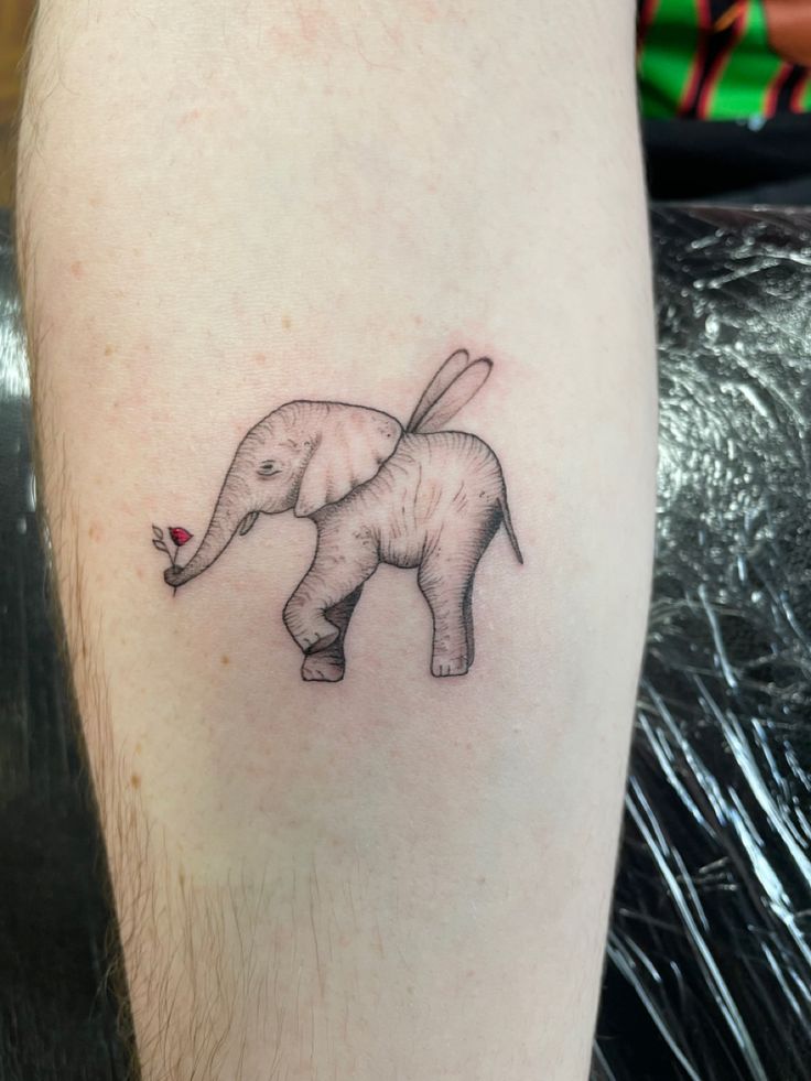 a small elephant tattoo on the right thigh, with a red heart in it's trunk