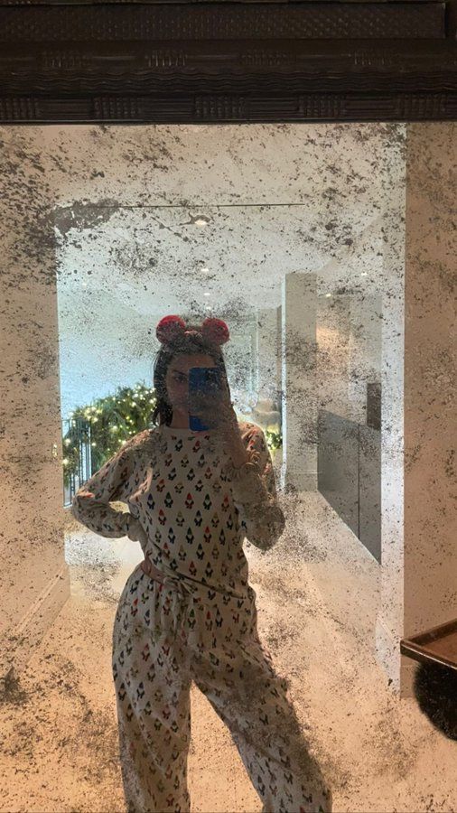 a woman taking a selfie in front of a mirror