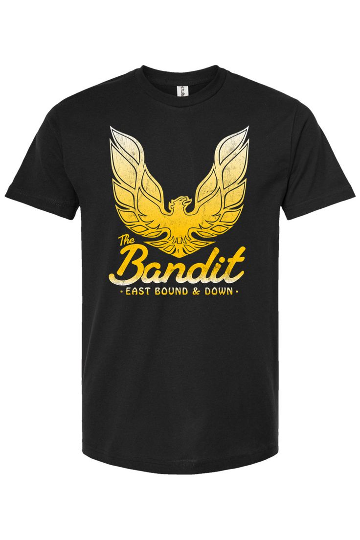 Get ready to hit the road with our retro-inspired "The Bandit - East Bound & Down" tee! Channeling the spirit of Burt Reynolds' iconic character, this tee is perfect for fans of classic films and highway adventures. Buckle up, because this shirt is bound to turn heads from east to west! 4.5 oz./yd², pre-shrunk 100% ring-spun USA cotton, 30 singles Heather Grey is 90/10 ring-spun cotton/polyester Other Heathers are 50/50 ring-spun cotton/polyester Reactive-dyed for longer lasting color Ribbed cre Band Merch T-shirt For Fan Events, Band Logo T-shirt Fan Apparel, Band Logo T-shirt For Fan Merchandise, Band Logo T-shirt For Fans, Country Backgrounds, The Bandit, Burt Reynolds, Hit The Road, 30 And Single