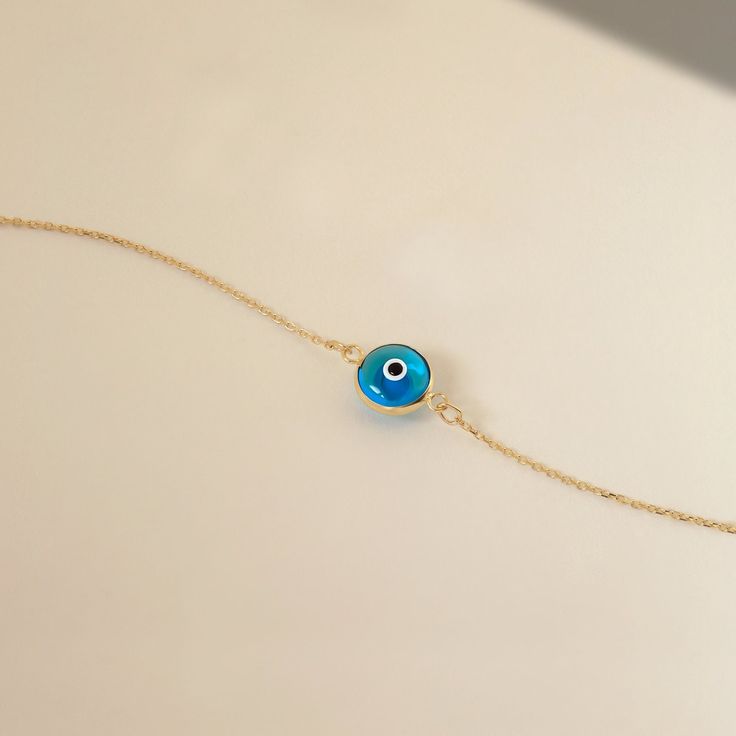 1- D E S C R I P T I O N Protect yourself with a touch of elegance wearing this 14K Solid Gold Blue Evil Eye Bracelet for Women, featuring a captivating blue evil eye design that adds a beautiful and stylish charm to your wrist. 2- P R O D U C T ∙  F E A T U R E S * Gold Material: 14K solid gold * Gold Color Options: Yellow gold, Rose gold, White gold * Chain Length Options: 5", 5.5", 6", 6.5", 7" +1" Extender * Dimensions:  Height: 9 mm / 0.35 in 3- D E L I V E R Y ∙ D E T A I L S We understand Elegant Round Turquoise Bracelet, Elegant Turquoise Round Bracelet, Turquoise Evil Eye Bracelet Jewelry, Elegant Adjustable Blue Gold Bracelet, Elegant Blue Adjustable Gold Bracelet, Elegant Blue Evil Eye Bracelet, Blue Gold Bracelet For Gift, Fine Jewelry, Elegant Turquoise Jewelry With Evil Eye, Fine Jewelry Blue Gold Bracelet For Gift