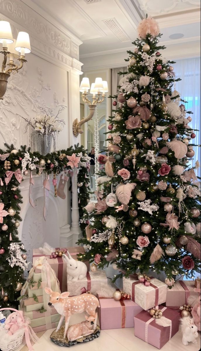 a decorated christmas tree in a room with pink and white presents on the floor next to it