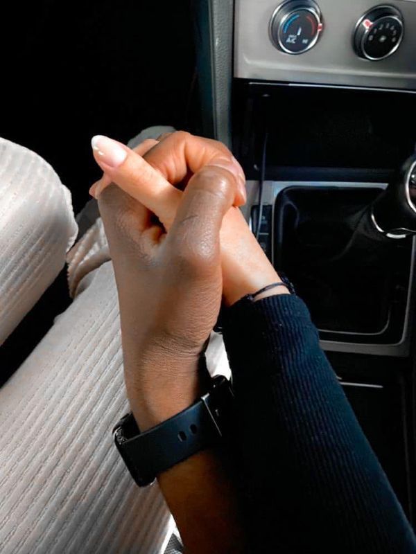 a person holding their hand up in the car