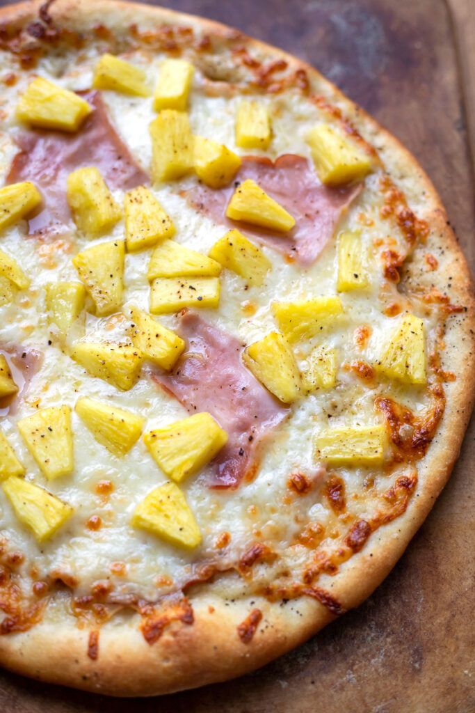 a pizza with pineapple and ham on it