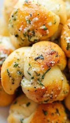 garlic bread rolls on a plate with parmesan sprinkles and herbs