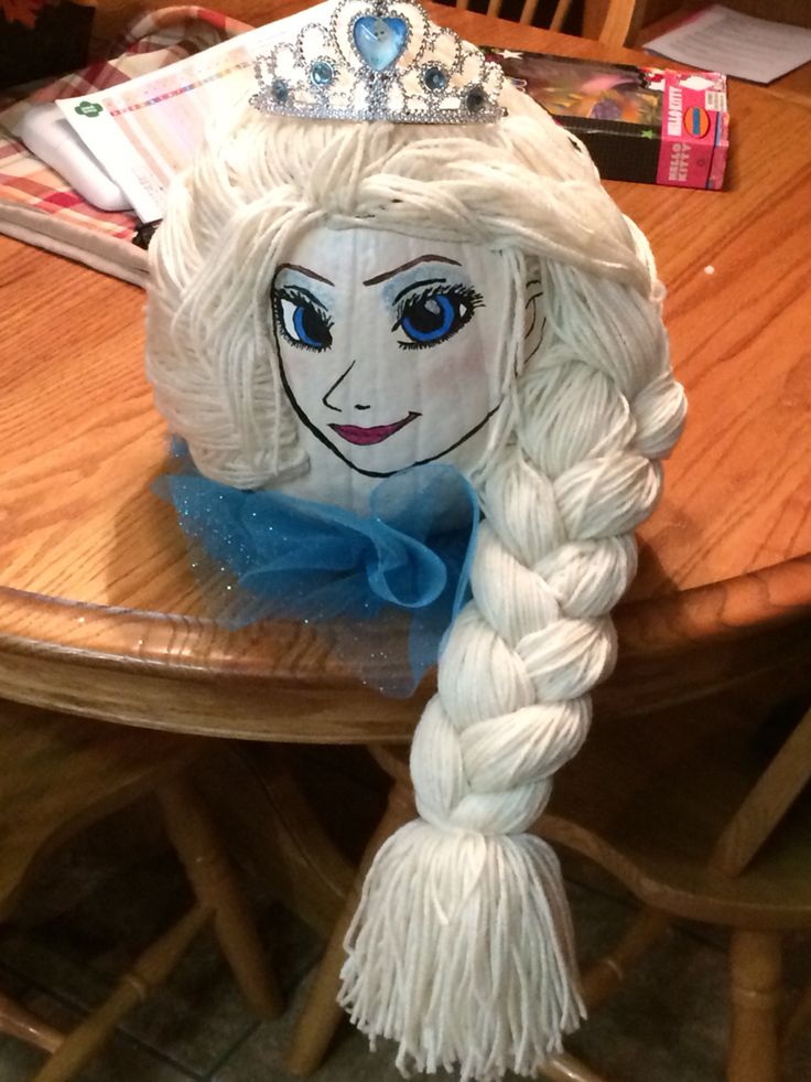 a frozen princess hat sitting on top of a wooden table