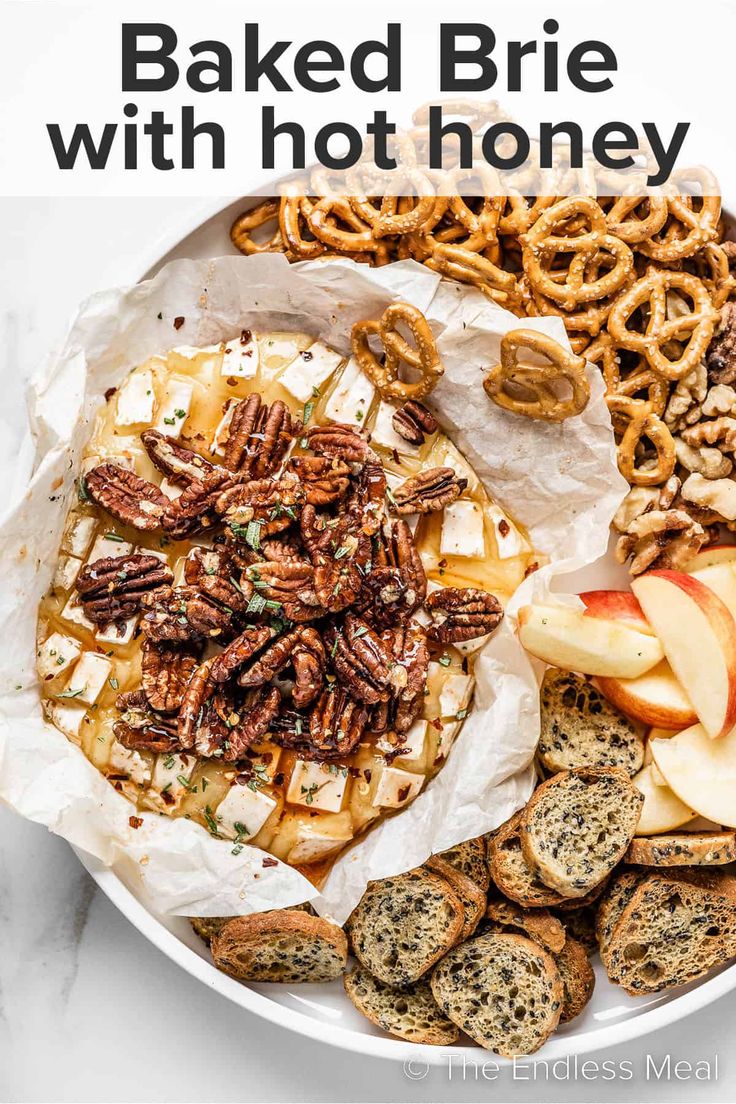 baked brie with hot honey, apples and pretzels in a white bowl