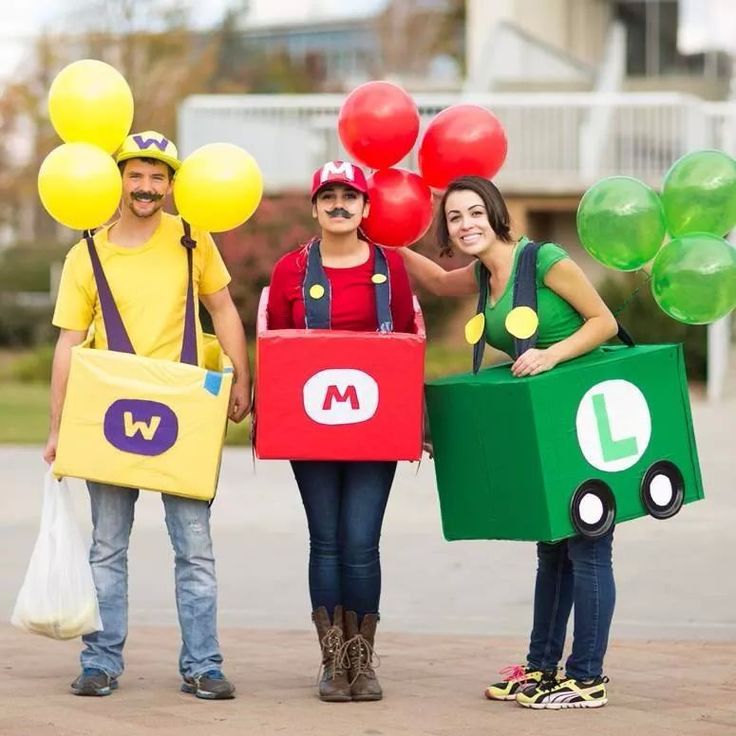 three people dressed up as mario and luigi from mario kart with balloons on their heads