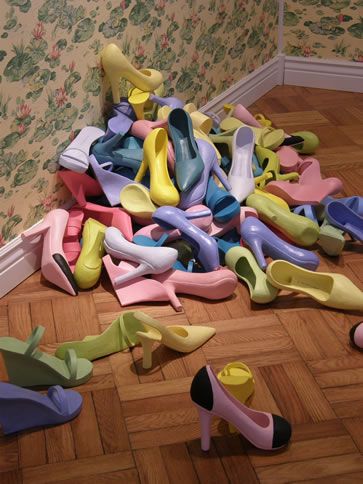 many pairs of shoes are scattered on the floor