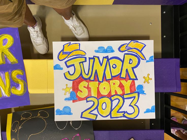 a sign that says junior story 2012 on it and some kids's shoes are in the background