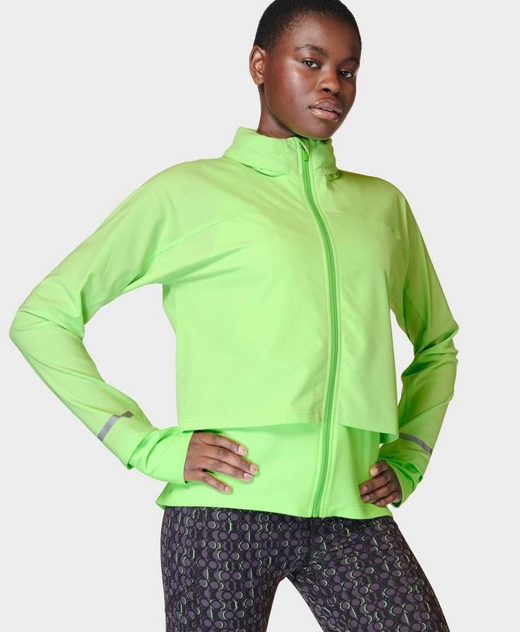 Our lightweight running jacket for everyday training. Part-recycled fabric is water-resistant with a sweat-wicking underlayer. Slim fit with a full centre zip and drop-back hem. Features a versatile pack-away hood. Reflective trim and hidden back pocket with zip. Front length: 62cm / 24”. Model wears size S and is 178cm/5'10" tall. Style Code: SB9712Colour: Zest Green Breathable Athleisure Windbreaker For Running, Windproof Sportswear For Running, Windproof Sportswear For Athletic Use, Functional Stretch Windbreaker For Workout, Functional Winter Windbreaker For Running, Functional Breathable Windbreaker For The Gym, Functional Nylon Track Jacket For Sports, Functional Breathable Windbreaker For Gym, Sporty Breathable Windbreaker For Running