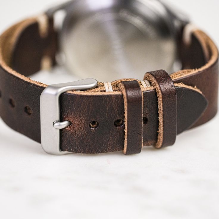 Our classic 2-piece custom watch straps feature Horween Leather in multiple color options with natural stitching. Straps feature a thumbnail style buckle and leather strap stays. As you wear your strap, you will notice how quickly it breaks in and molds to your wrist creating an incredibly comfortable fit. And with daily wear, it will deepen in color and patina becoming a piece completely unique to you.• Handmade watch band in Horween Leather• Simple stitching in Natural waxed polyester thread• Classic Leather Strap Watch Bands For Everyday Use, Vintage Leather Watch Accessories For Everyday Use, Classic Watch Bands With Waxed Finish For Everyday Use, Classic Leather Watch Bands With Stainless Steel Clasp, Vintage Leather Strap Watch Bands For Everyday Use, Brown Leather Strap For Round Dial Watches, Leather Watch Bands For Everyday, Timeless Leather Watch Bands For Everyday, Classic Leather Watch Accessories For Everyday Use