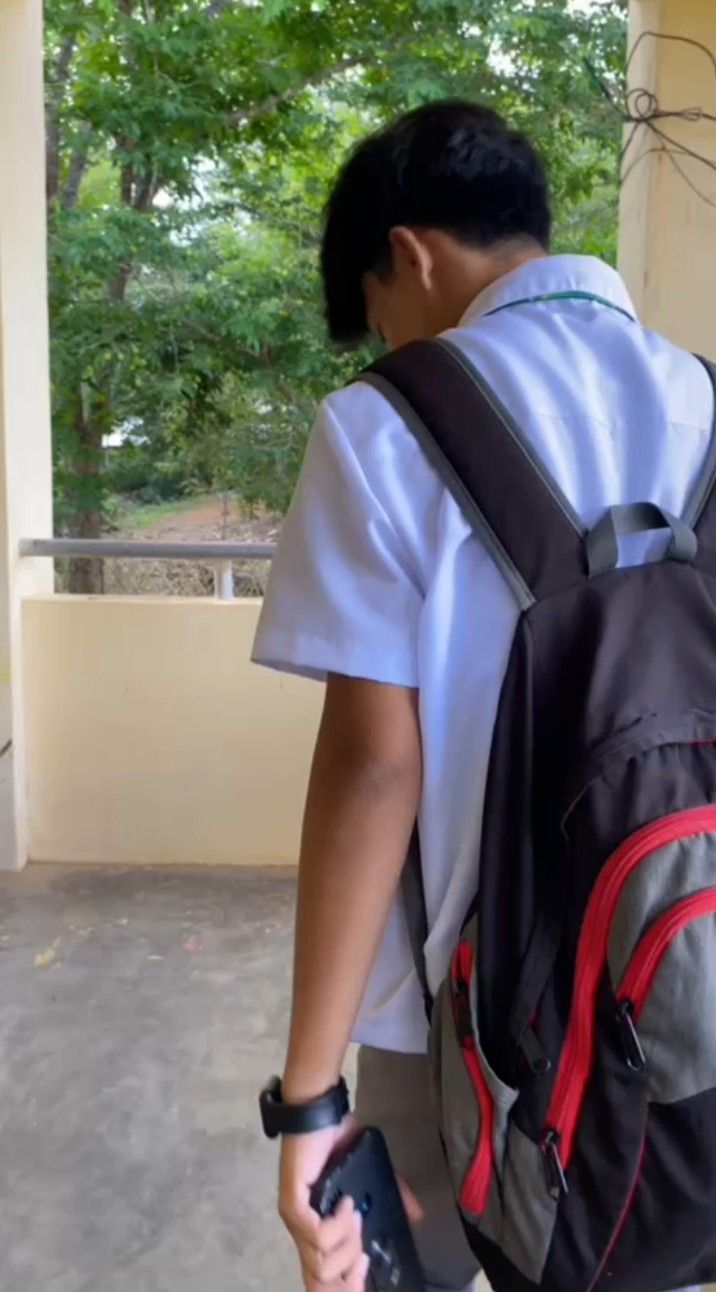 a young man with a backpack and cell phone