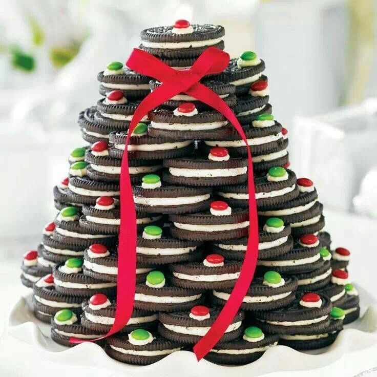 a christmas tree made out of cookies on a plate with a red ribbon around it