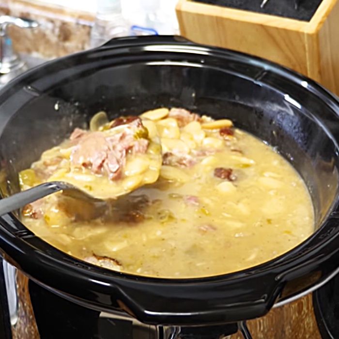 a pot filled with soup sitting on top of a stove