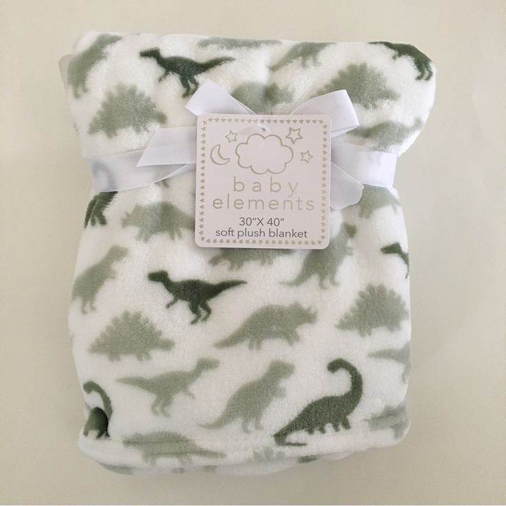 a baby blanket with an image of dinosaurs on it