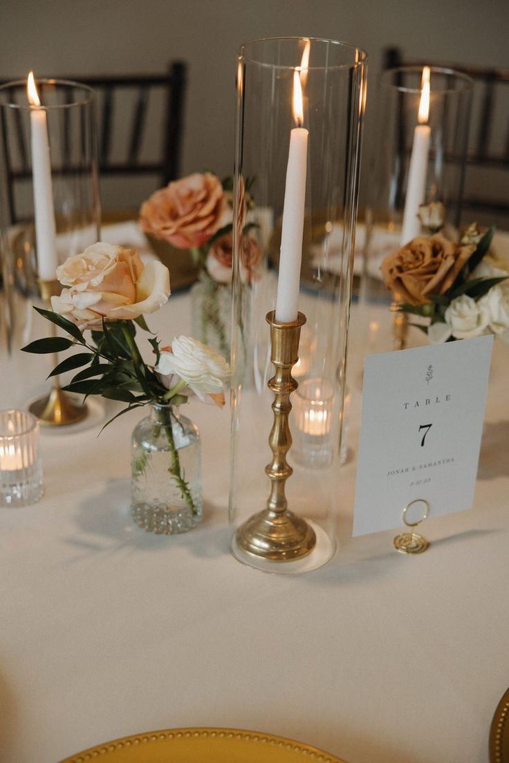 the table is set with candles and flowers