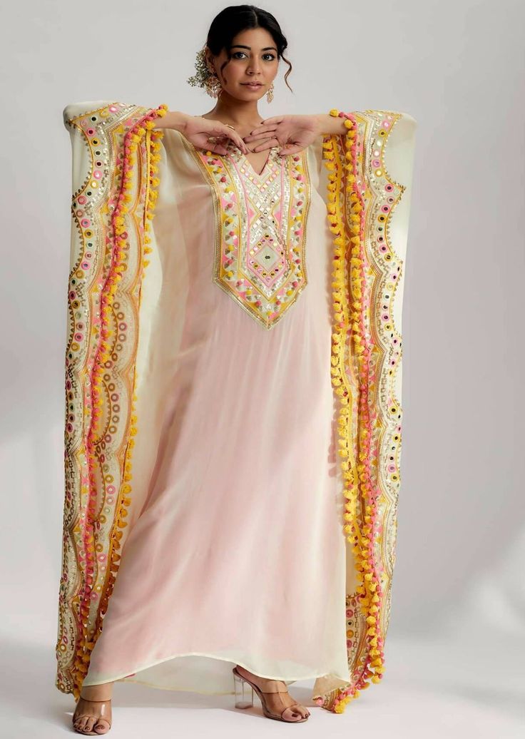 Each intricate detail on the miraan scallop kaftan is carefully handcrafted by skilled artisans, showcasing their expertise and dedication to creating a truly exceptional garment. The combination of hand and machine embroidery techniques ensures precision and durability, ensuring that every sequin and stitch remains intact even after multiple wears. Silk Kaftan With Resham Embroidery For Designer Wear, Silk Floor-length Kaftan With Dabka Work, Semi-stitched Kaftan For Designer Wear, Bollywood Style Festive Kaftan With Floral Embroidery, Festive Bollywood Kaftan With Floral Embroidery, Traditional Multicolor Designer Kaftan, Designer Embroidered Kaftan For Festivals, Designer Wear Embellished Floor-length Kaftan, Unstitched Floor-length Kaftan For Eid