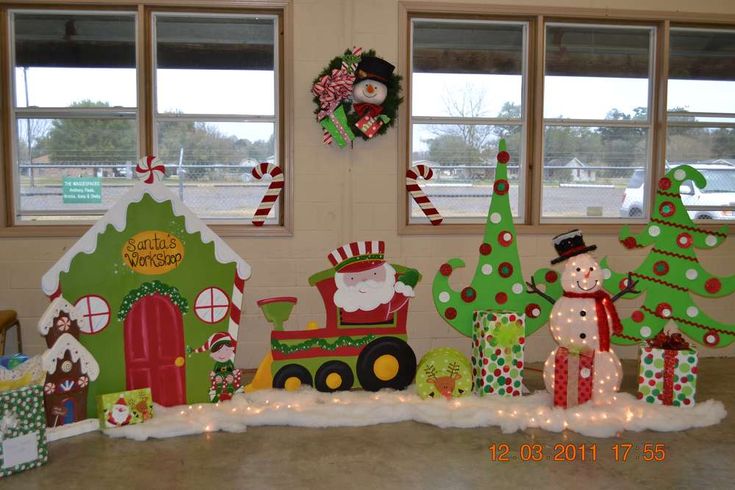 christmas decorations are displayed in front of windows