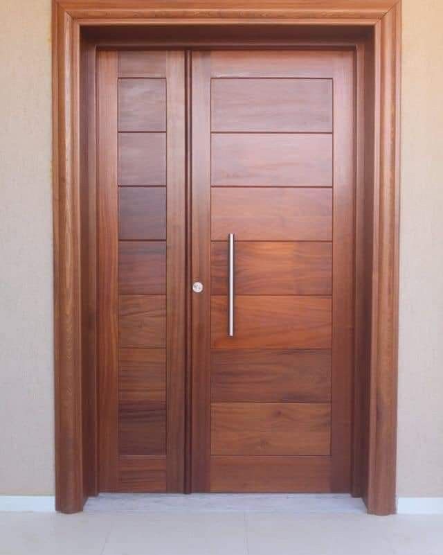 two wooden doors in front of a beige wall