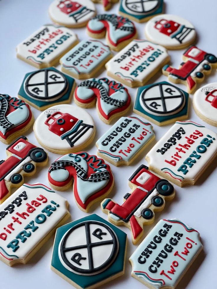 many decorated cookies are arranged on a table