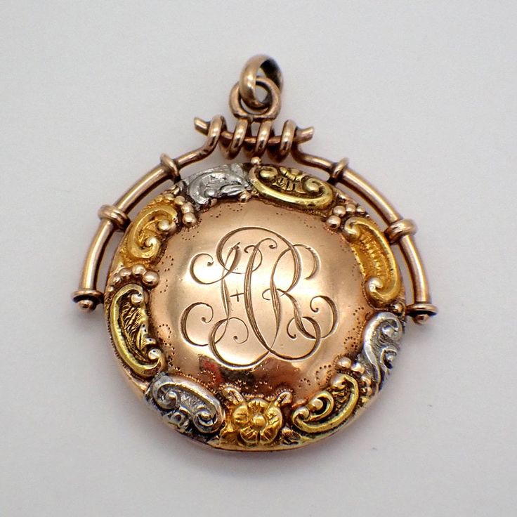 "Vintage 14 K (.585) rose gold round form locket pendant, decorated with three-tone gold repousse scroll border. In the center, there is an engraved curly script monogram \"HR\". The locket has a picture compartment inside. This lovely locket is 1 1/8\" wide and 1 1/4\" long, weighing 6.7 grams. It features minor dents. EA2832" Antique Medallion Metal Locket Necklace, Gold-tone Round Pendant Locket, Antique Yellow Gold Medallion Locket Necklace, Gold-tone Round Locket Necklace, Luxury Gold-tone Locket Necklace, Rose Gold Locket, Antique Jewelry Necklace, Bead Bar, Script Monogram