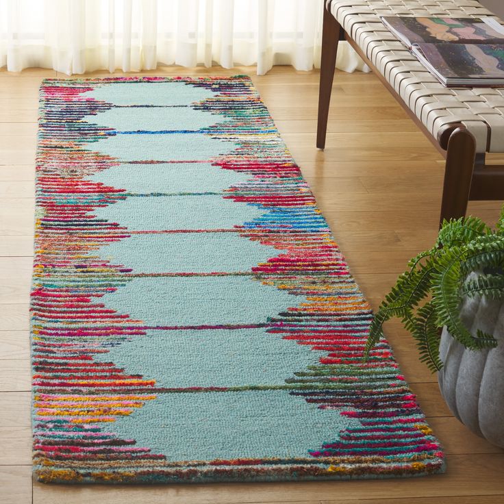 a multicolored rug on the floor in a living room