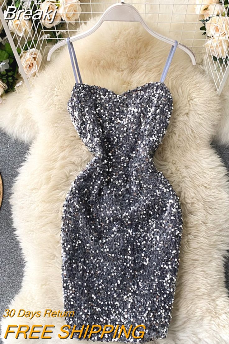 a black and white dress hanging on a rack in front of a flowery background