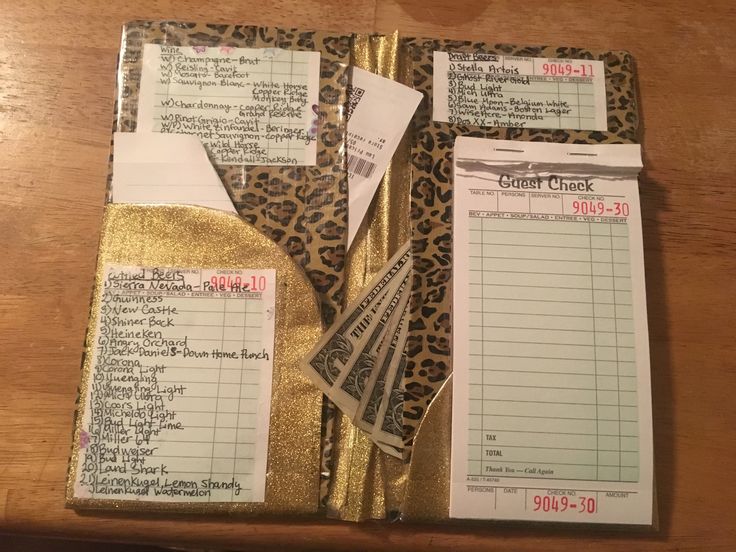 several bills are wrapped in gold foil on top of a wooden table