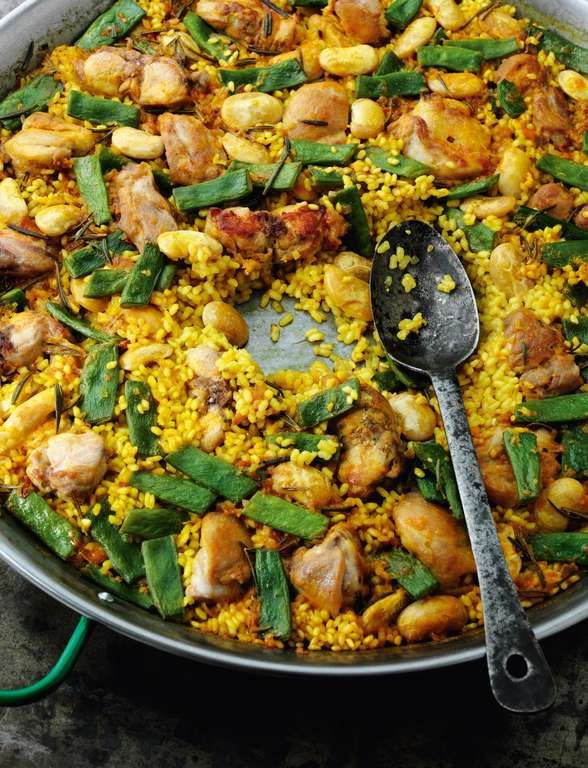 a pan filled with rice, chicken and veggies