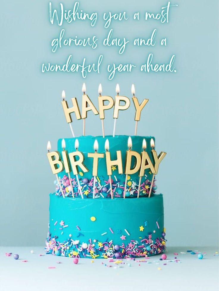 a blue birthday cake with candles and confetti on it that says wishing you a most glorious day and a wonderful year ahead