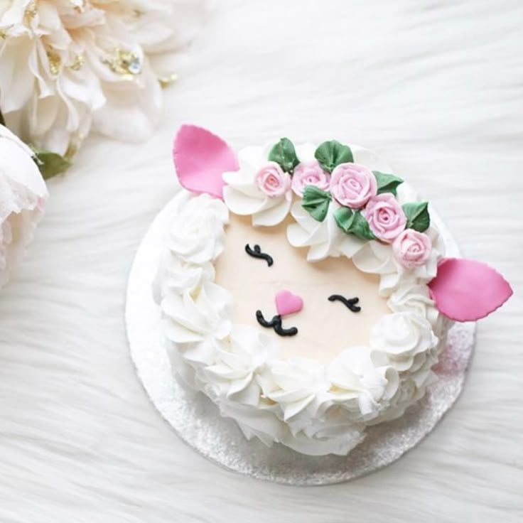 a cake decorated with white frosting and pink flowers