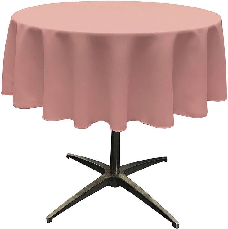 a round table with a pink cloth on it