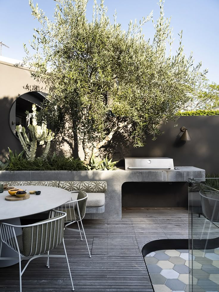 an outdoor dining area with table and chairs